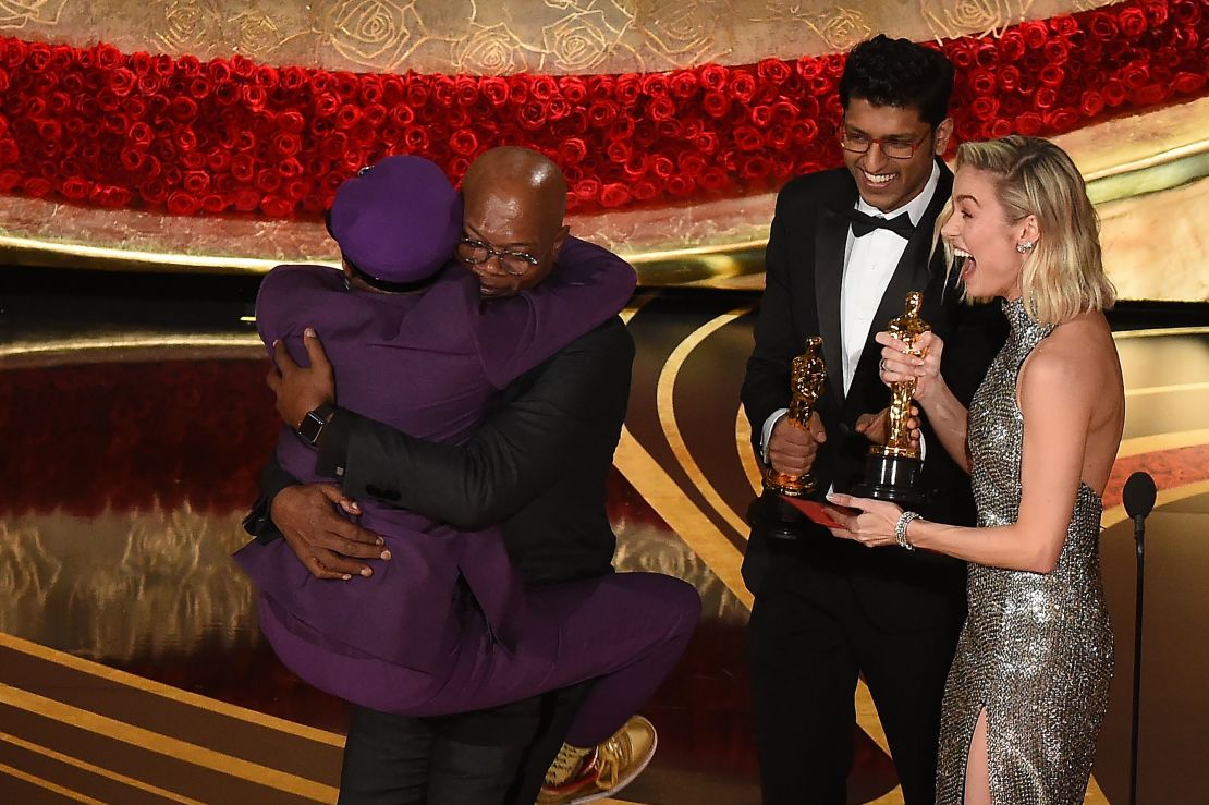 Spike Lee jumps in the arms of Actor Samuel L. Jackson as he accepts the award for best adapted screenplay 