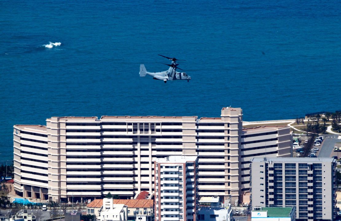An US aircraft MV-22 Osprey flies over the residential area of Ginowan City to land the US Marine Corps Futenma Air Station on October 1, 2012 in Ginowan, Okinawa, Japan. 