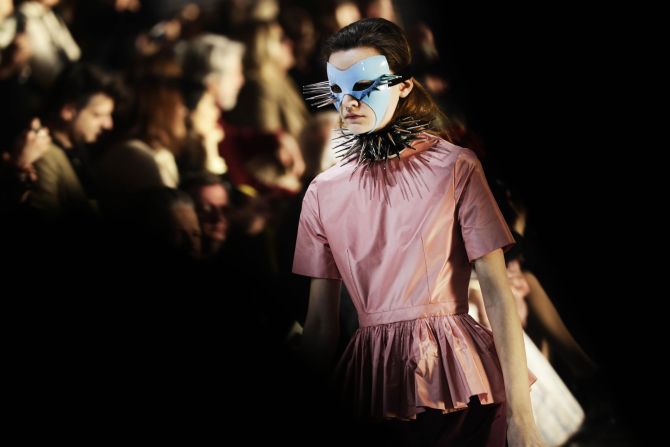 Gucci's Alessandro Michele sent masked models down a mirrored runway in front of a dazzling strobe light display.