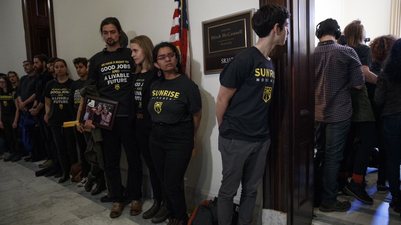 Activists with the Sunrise Movement protest at Senate Majority Leader Mitch McConnell's office in the Russell Senate Office Building on Capitol Hill in Washington on Monday. Activists from around the country joined Kentucky high schoolers trying to confront Mitch McConnell about his rush to vote on the Green New Deal.