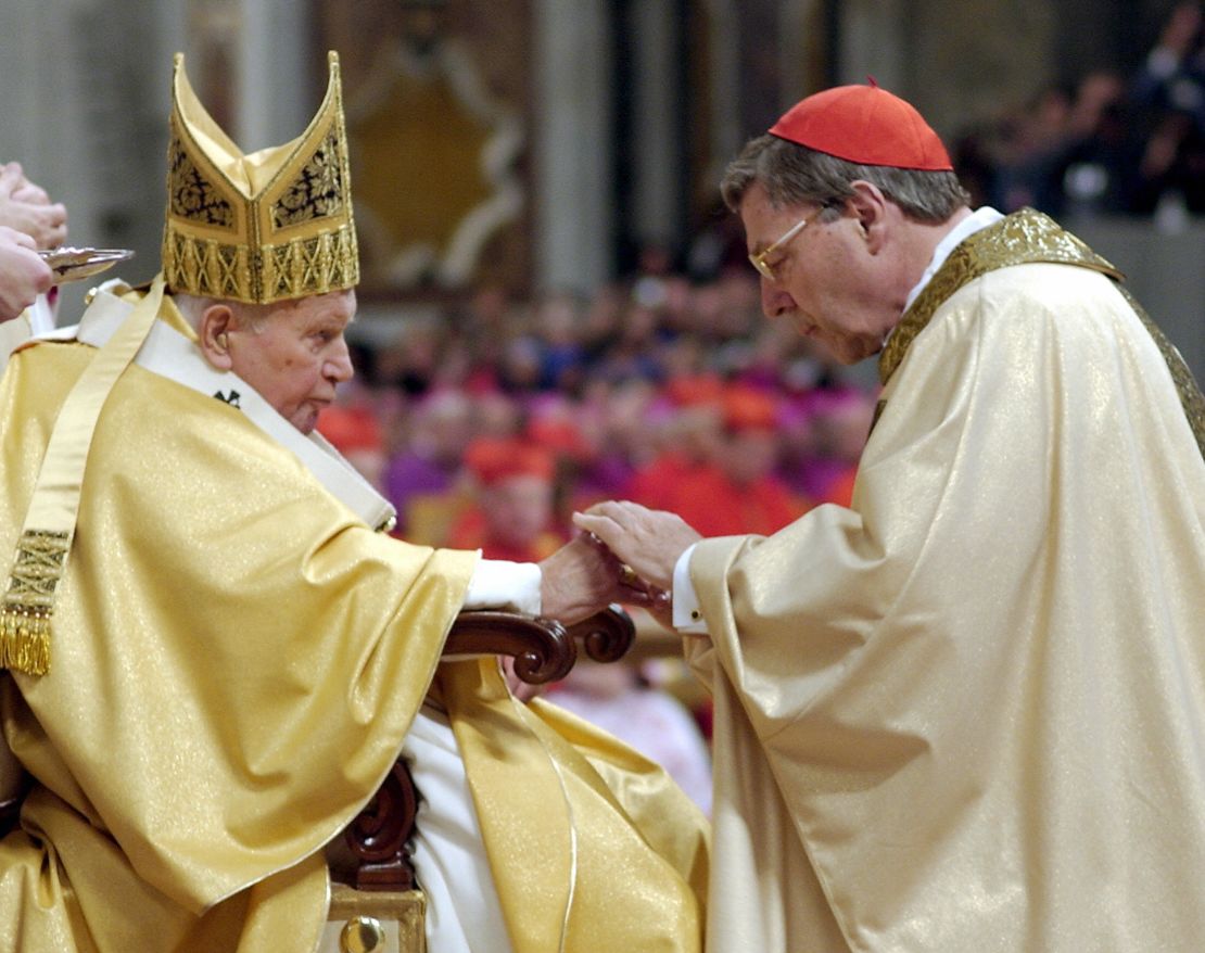 Pope John Paul II (L) gives his cardinal ring to George Pell of Australia inside St Peter Basilica 22 October, 2003, at the Vatican. 