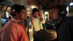 In this Friday, June 24, 2011 photo, party goers listen to music using wireless headphones during first ever 'silent noise party' in Bangalore, India. The concept of silent noise parties common in western countries to bring down the noise levels, where one can listen to the music only through the cordless headphones connected to the system of Disc Jockey. (AP Photo/Aijaz Rahi)