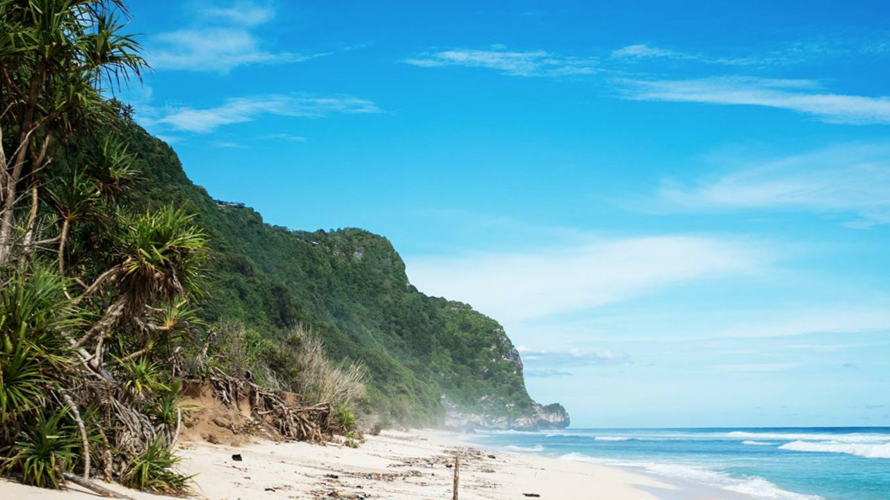 Bali's Nyang Nyang beach is a mile-long strip of golden sand, framed by jungled cliffs, green meadows and blue ocean. 