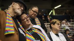 Ed Rowe, left, Rebecca Wilson, Robin Hager and Jill Zundel, react to the defeat of a proposal that would allow LGBT clergy and same-sex marriage within the United Methodist Church at the denomination's 2019 Special Session of the General Conference in St. Louis, Mo., Tuesday, Feb. 26, 2019. America's second-largest Protestant denomination faces a likely fracture as delegates at the crucial meeting move to strengthen bans on same-sex marriage and ordination of LGBT clergy. (AP Photo/Sid Hastings)