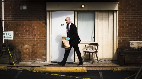 An investigator carries out items from the Robert Morris Apartments in Morrisville, Pa., Tuesday.