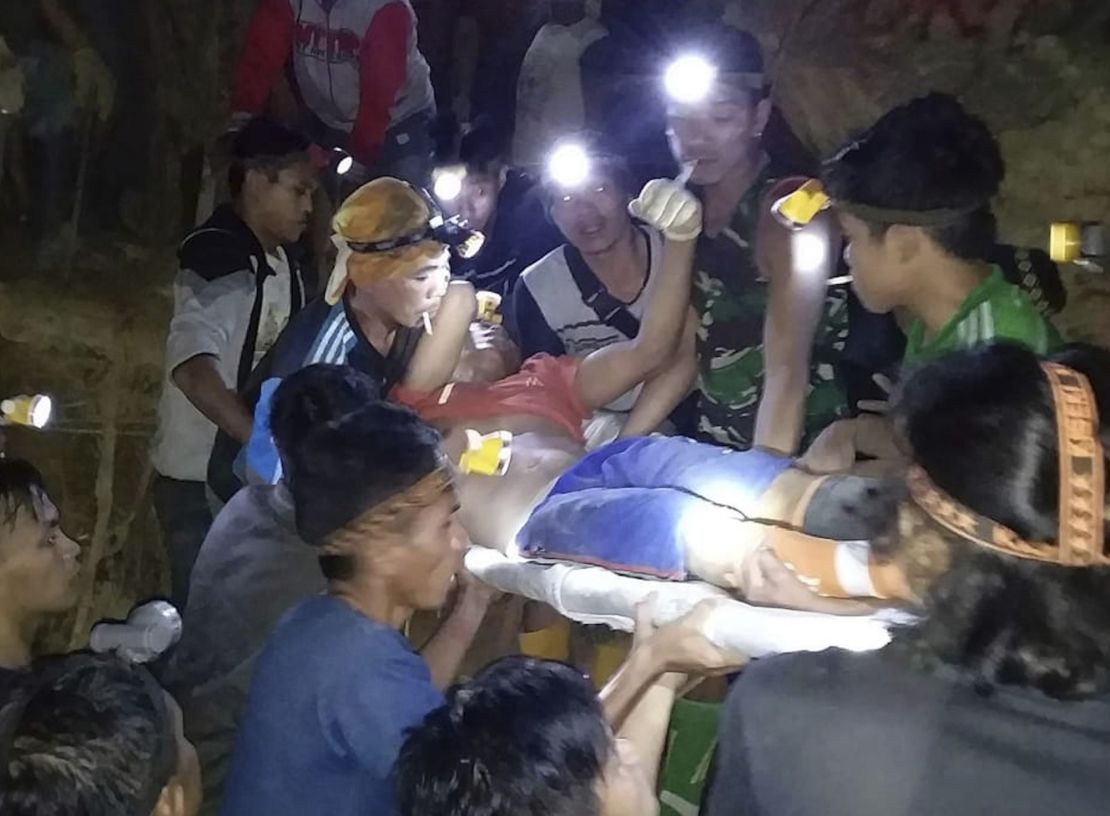 Indonesian Search And Rescue Agency (BASARNAS) rescuers evacuate a survivor from a collapsed gold mine in Bolaang Mongondow, North Sulawesi, Indonesia. 