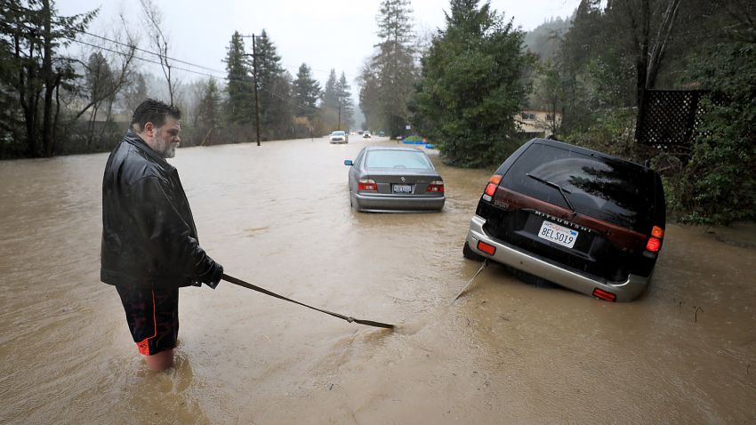Tim Russell of Guerneville attempts to pull a motorist from Armstrong Woods Road after it became inundated in Guerneville, Calif., Tuesday, Feb. 26, 2019, but Russell became stuck himself. The town of Guerneville and some two dozen other communities are at risk of flooding from the Russian River north of San Francisco, which hit flood stage Tuesday evening and was expected to peak Wednesday morning at more than 46 feet - the highest point in nearly a quarter-century. (Kent Porter/The Press Democrat via AP)