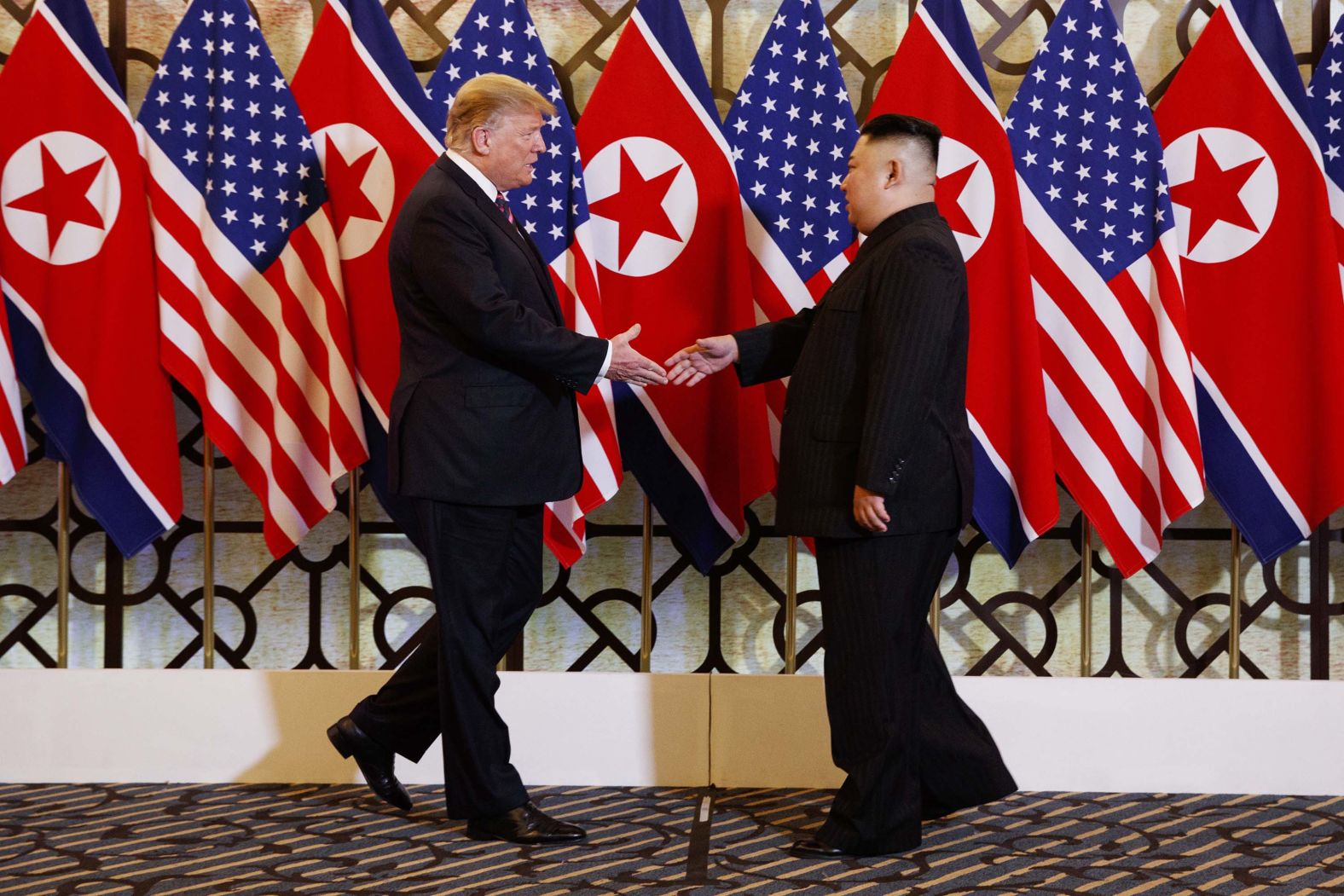 Trump and Kim greet each other before having dinner together on February 27. It was the first time they had seen each other since their previous summit in June.
