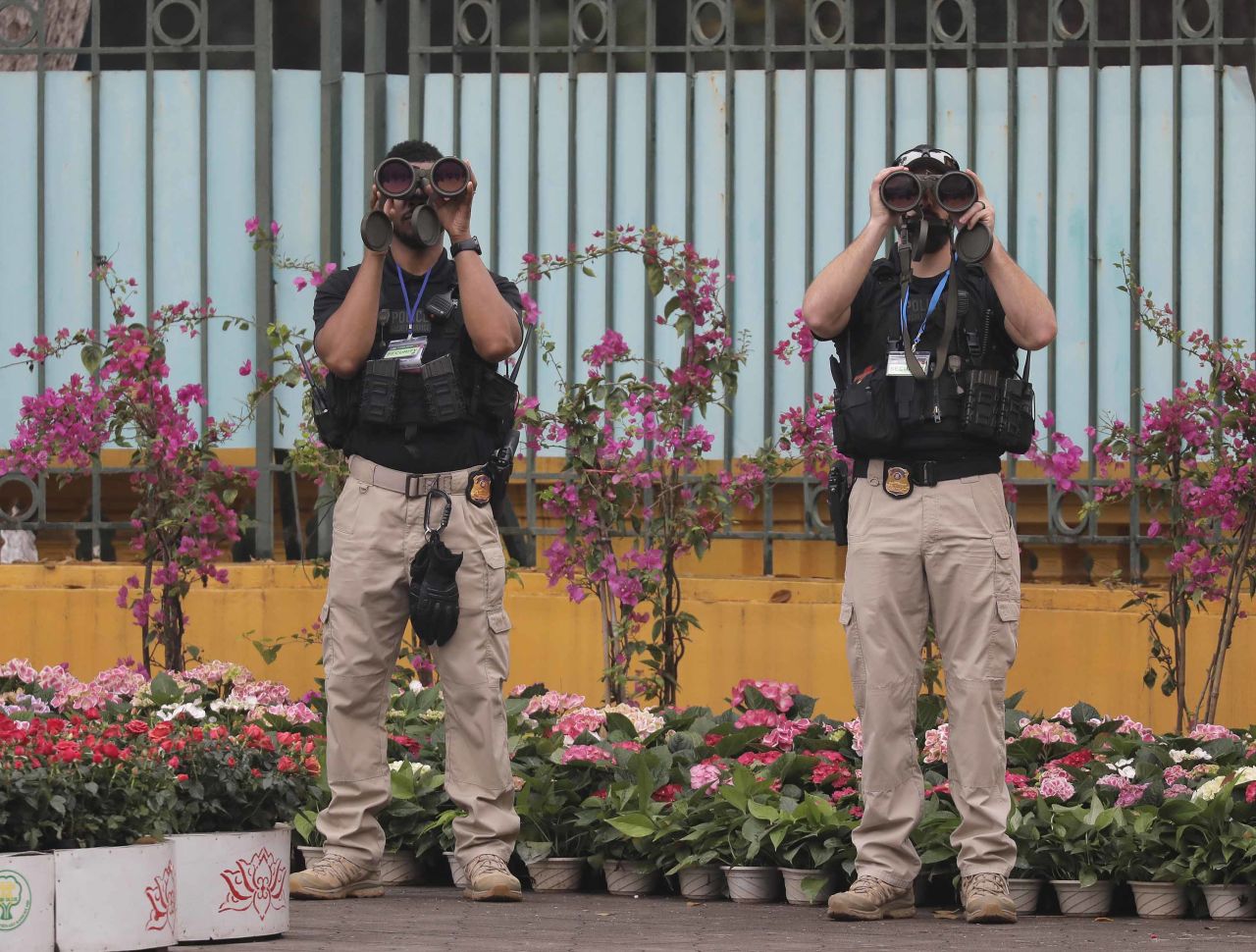 US security officers scan the area outside the Presidential Palace before Trump met with Vietnamese leaders.