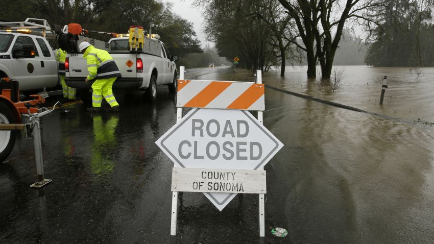 Rising flood water makes its way onto River Road Wednesday, Feb. 27, 2019, in Forestville, Calif. A river in Northern California's wine country has reached flood stage and forecasters expect it to rise even more as a winter storm lashes the region. The National Weather Service says the Russian River in Sonoma County topped 32 feet Tuesday evening and it could crest at more than 46 feet by Wednesday night. (AP Photo/Eric Risberg)