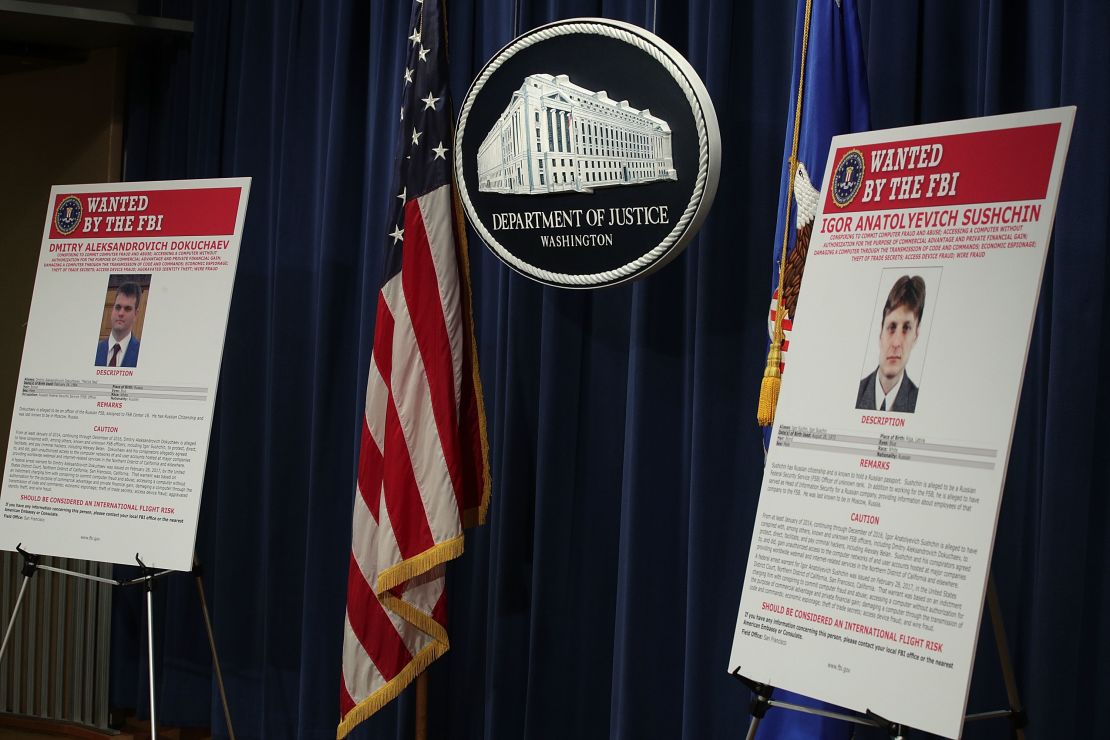 A wanted poster for FSB officer Dmitry Aleksandrovich Dokuchaev is displayed at the Justice Department on March 15, 2017.