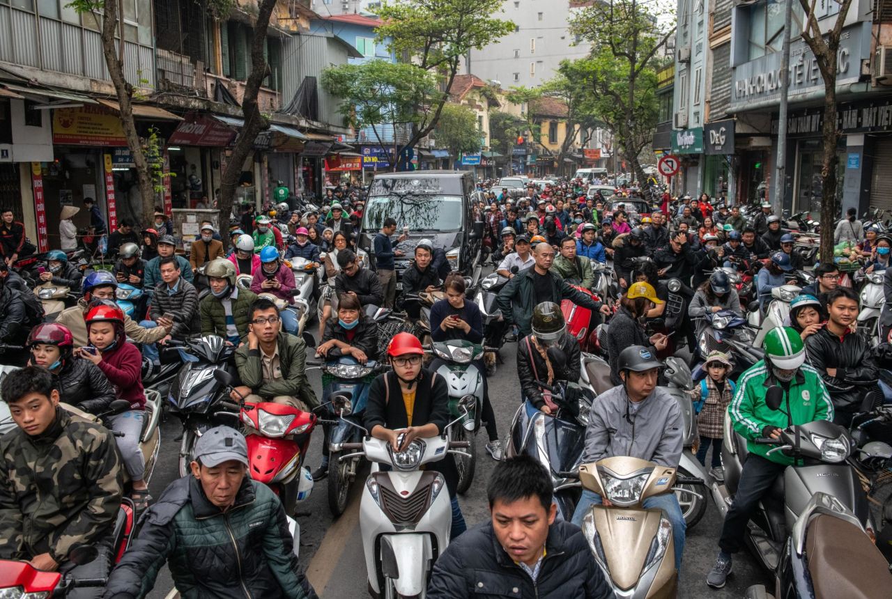 Hanoi residents wait as a road is blocked for Trump's motorcade on February 28.