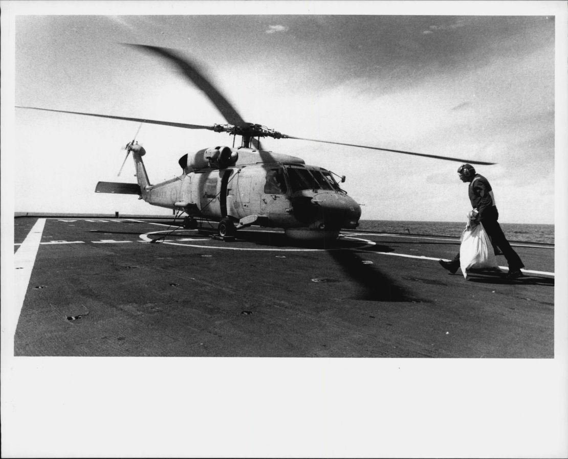 A chopper picks up mail bag to be taken to Diego Garcia in September, 1990. 
