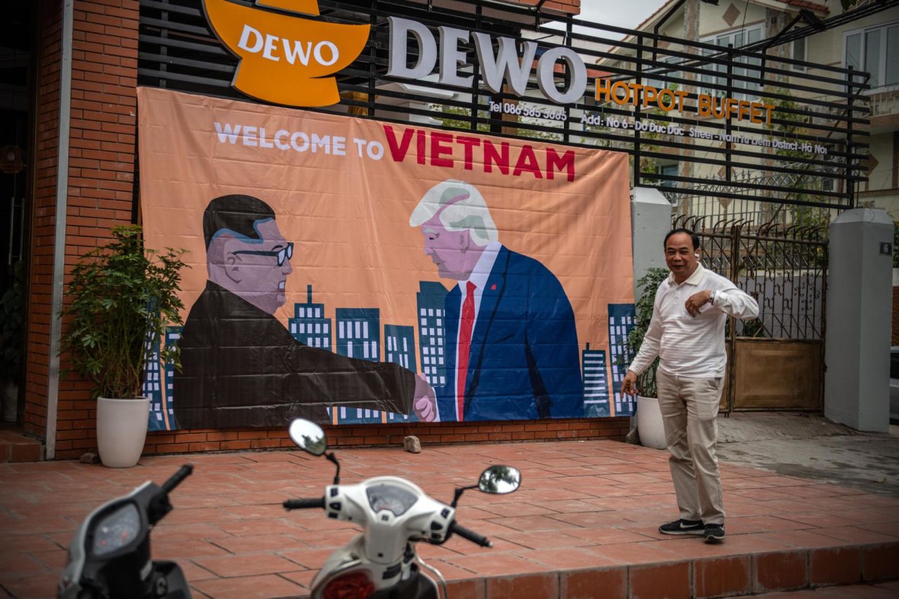 A banner showing US President Donald Trump and North Korean leader Kim Jong Un shaking hands next to the words "Welcome to Vietnam." 