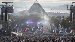 GLASTONBURY, ENGLAND - JUNE 25:  People gather in front of the Pyramid Stage  at Worthy Farm in Pilton on June 25, 2017 near Glastonbury, England. Glastonbury Festival of Contemporary Performing Arts is the largest greenfield festival in the world. It was started by Michael Eavis in 1970 when several hundred hippies paid just ￡1, and now attracts more than 175,000 people  (Photo by Matt Cardy/Getty Images)