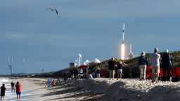People watch from Playalinda Beach at Canaveral National Seashore as a SpaceX Falcon 9 rocket successfully launches carrying the Es'hail-2 communications satellite for the country of Qatar on November 15, 2018 from pad 39A at the Kennedy Space Center in Florida, US.