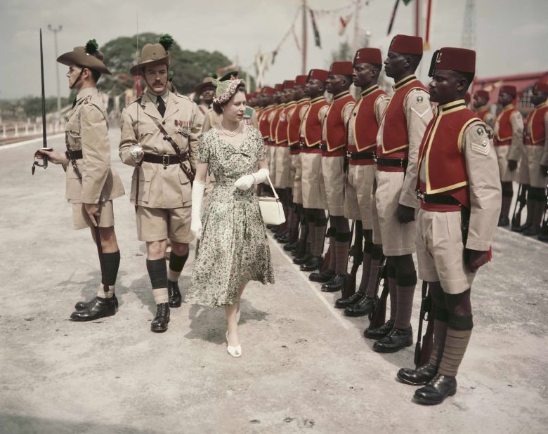 February 2, 1956: Queen Elizabeth inspects men of the newly-renamed Queen's Own Nigeria Regiment, Royal West African Frontier Force, at Kaduna Airport, Nigeria, in an elegant tea dress.