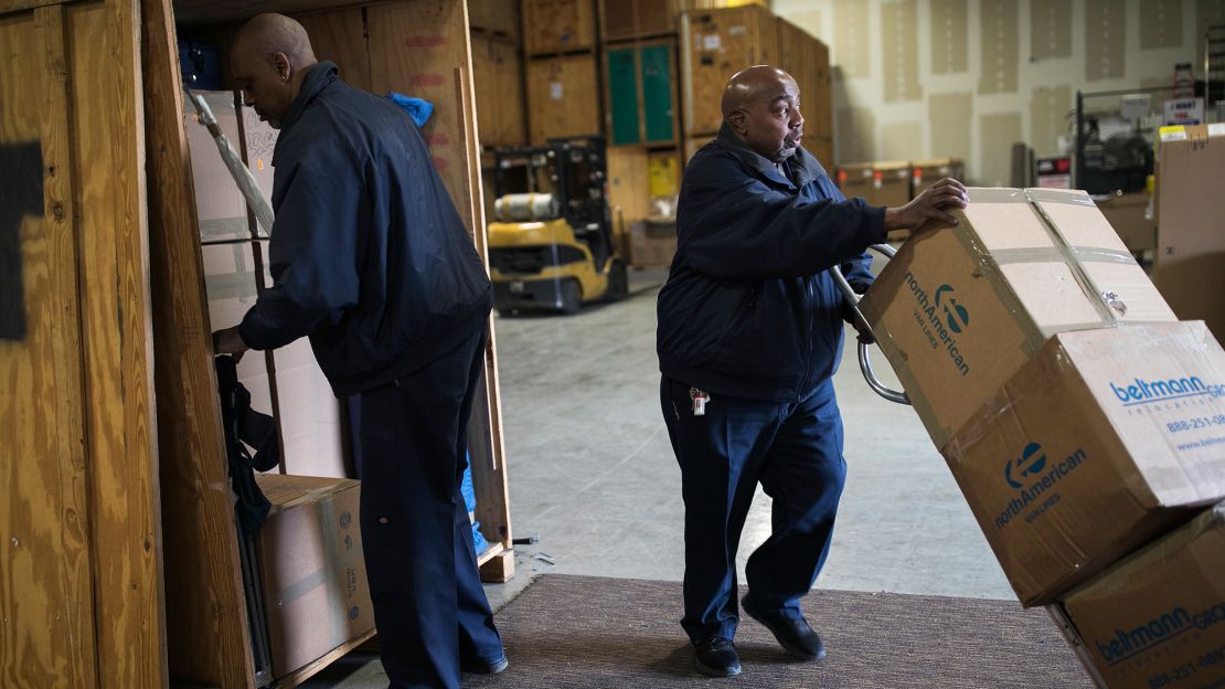 Jerome Davis, left, and Raleigh Head work in the warehouse of E.E. Ward. They have both worked at the company for more than 30 years. 