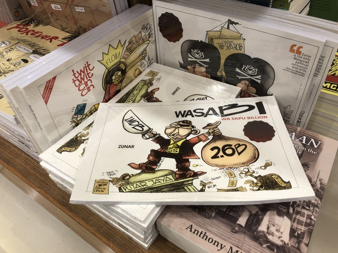 A collection of Zunar's books seen on sale in a Kuala Lumpur shopping mall in February 2019. In the past, multiple of the cartoonist's books were banned, and copies seized by the police.