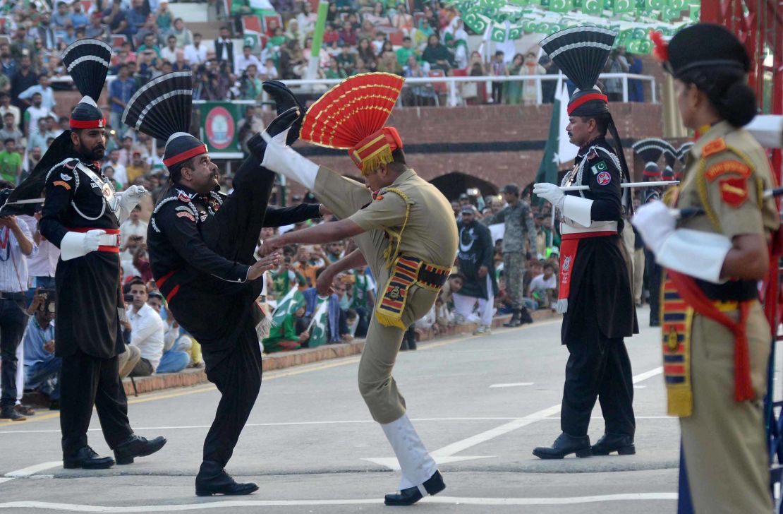 Pakistani rangers (L) and Indian security forces (R) perform the daily Beating Retreat ceremony at Wagah in August 2017.  