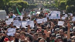 Algerians march with protest sings reading "peaceful", and "leave means leave" in Arabic, during a rally against ailing President Abdelaziz Bouteflika's bid for a fifth term in power, in the capital Algiers on March 1, 2019. - The demonstrations came a week after tens of thousands of people rallied in the North African state against 81-year-old Bouteflika's decision to stand in the April 18 election. (Photo by RYAD KRAMDI / AFP)        (Photo credit should read RYAD KRAMDI/AFP/Getty Images)