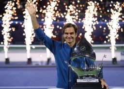 Roger Federer of Switzerland poses with the trophy after claiming his 100th career title.