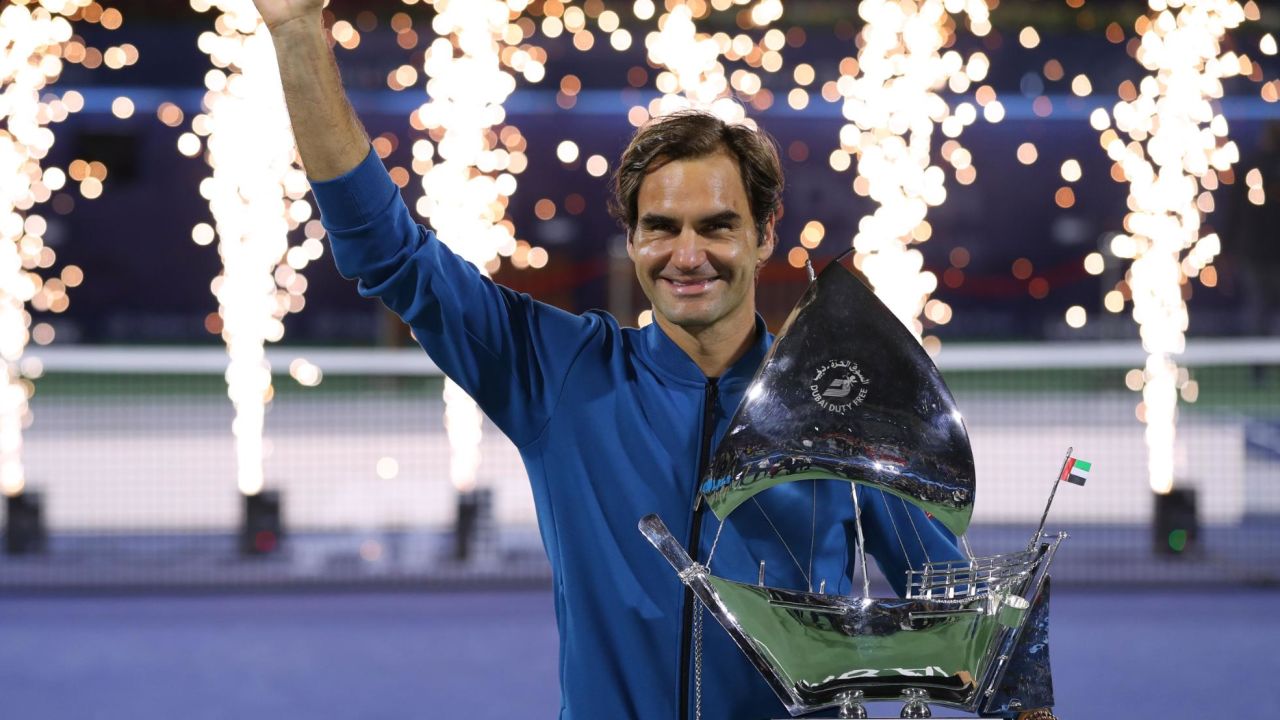 Roger Federer of Switzerland poses with the trophy after claiming his 100th career title.