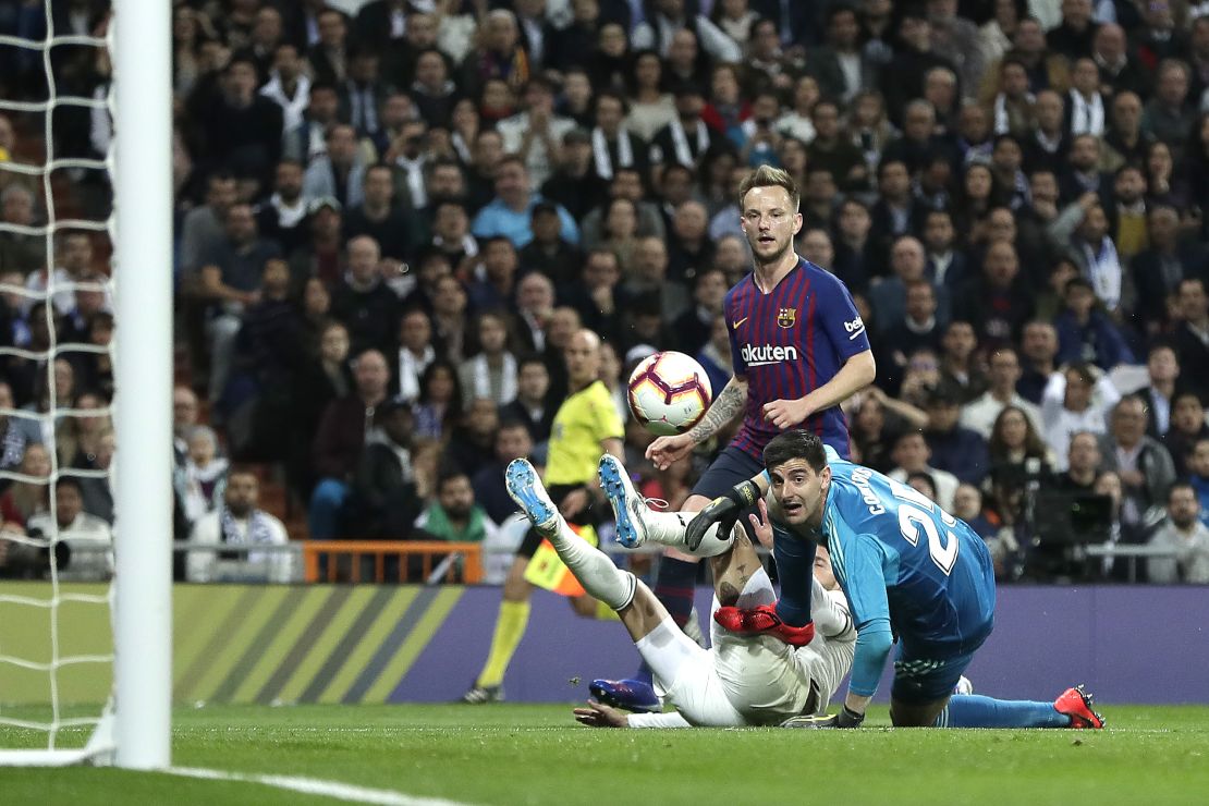 Ivan Rakitic chips the ball over the despairing Thibaut Courtois in the Real Madrid goal to score the opening goal of El Clasico.