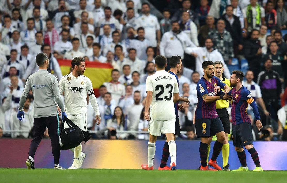 Lionel Messi reacts angrily to a challenge by Sergio Ramos as tempers flared in El Clasico. 