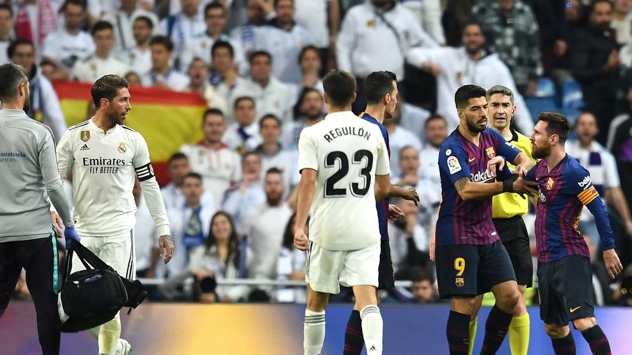 Lionel Messi reacts angrily to a challenge by Sergio Ramos as tempers flared in El Clasico. 