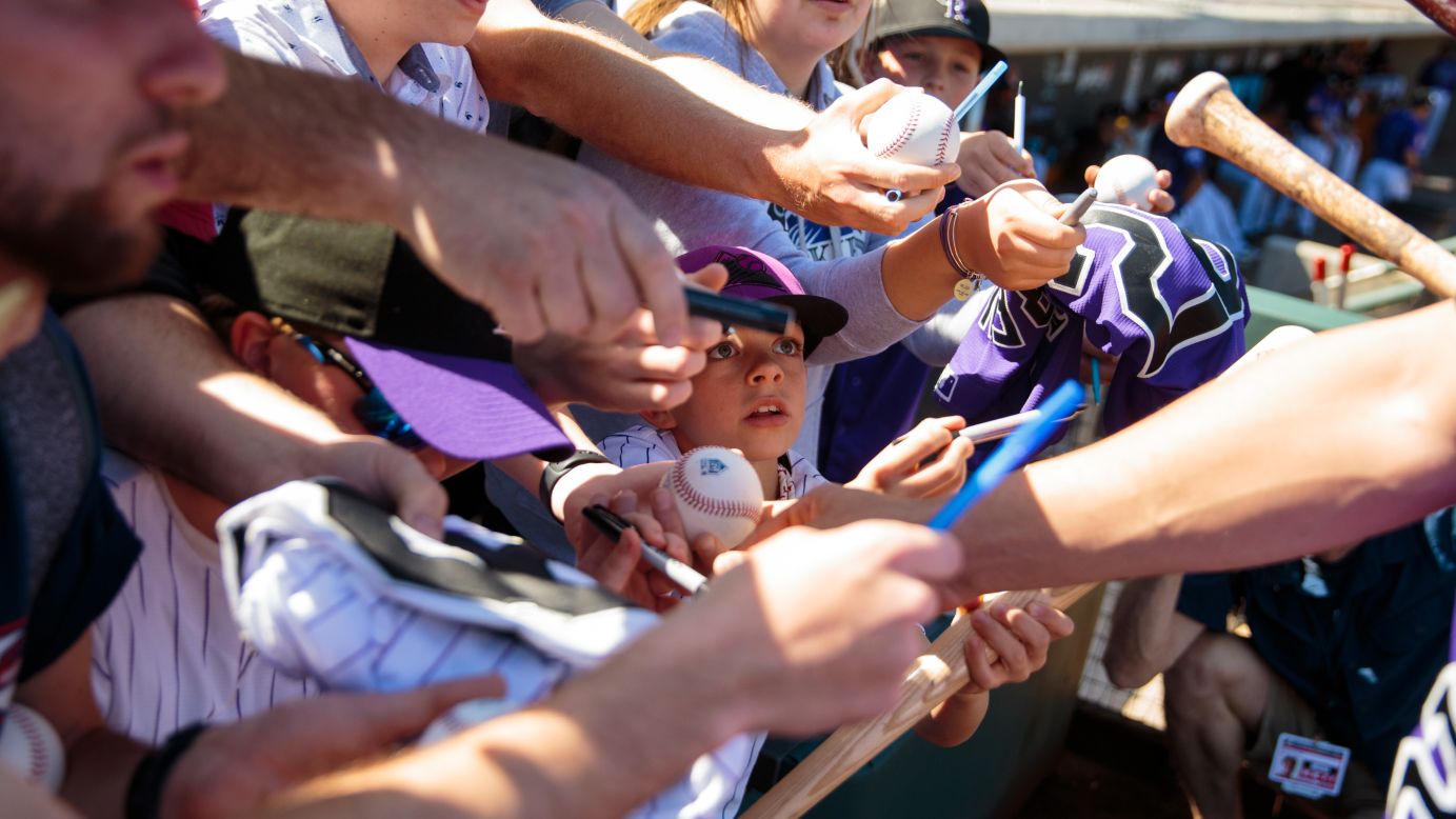 A young Colorado Rockies fan attempts to get an autograph prior to a spring training game between the Rockies and the Los Angeles Angels at Salt River Fields at Talking Stick on February 27, in Scottsdale, Arizona. 