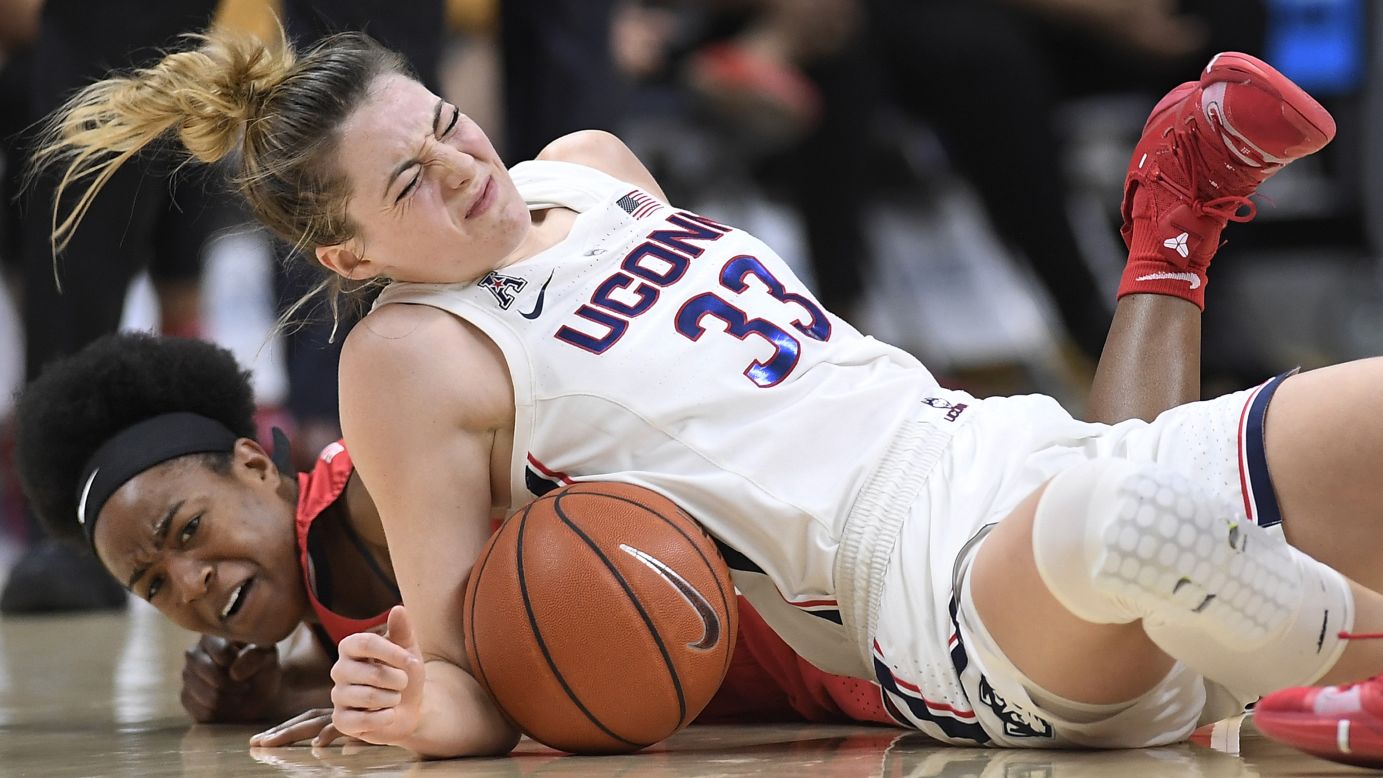 Connecticut Guard Katie Lou Samuelson, top, and Houston's Julia Blackshell-Fair fall to the court chasing a loose ball during the first half of an NCAA basketball game on Saturday, March 2, in Storrs, Connecticut.
