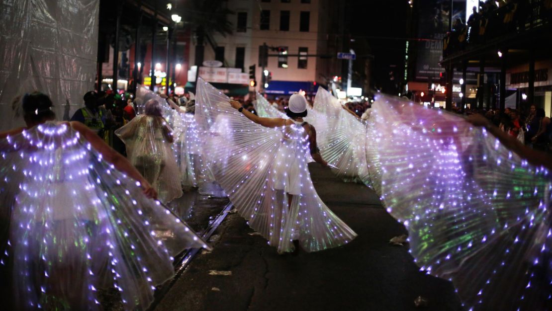 A marching group rolls with the Krewe of Muses through the streets of New Orleans.