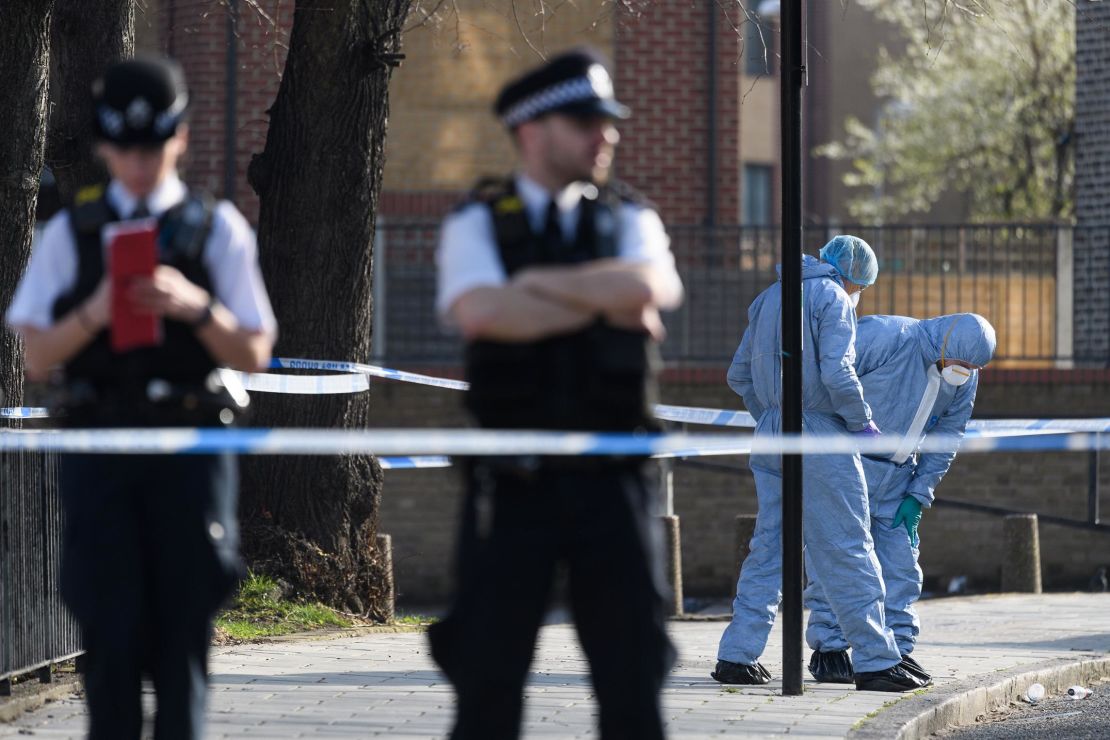 Forensic police officers investigate after a 23-year-old man was fatally stabbed in London in February.