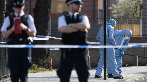 Forensic police officers investigate after a 23-year-old man was fatally stabbed in London in February.