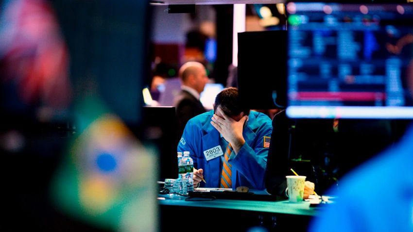 A trader works at his desk on the floor of the New York Stock Exchange (NYSE) after the opening Bell on March 4, 2019 in New York City.