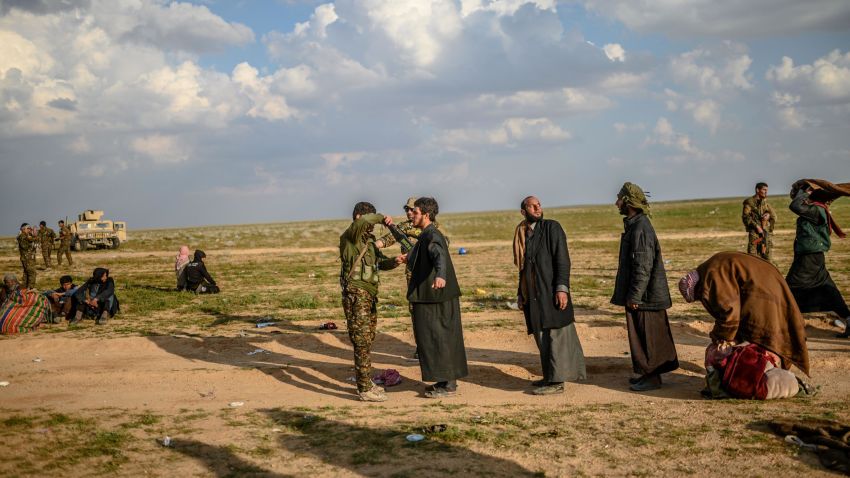 Men suspected of being Islamic State (IS) fighters are searched by members of the Kurdish-led Syrian Democratic Forces (SDF) after leaving the IS group's last holdout of Baghouz in Syria's northern Deir Ezzor province, on February 22, 2019. (Photo by Bulent KILIC / AFP)        (Photo credit should read BULENT KILIC/AFP/Getty Images)