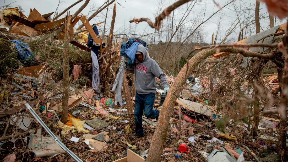 Danny Allen helps recover belongings from what's left of a friend's home in Beauregard on March 4.