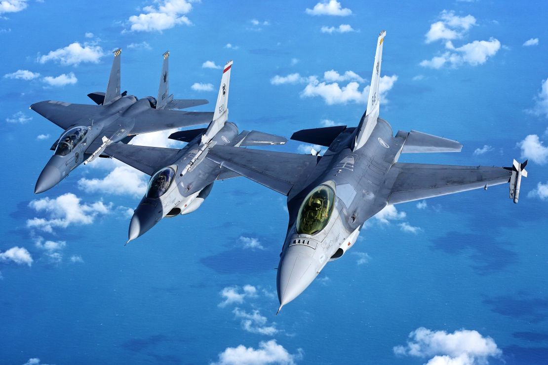 Two Singaporean F-16s fly in formation with an F-15 in 2017. The country's defense minister says the F-16s will be obsolete by 2030.
