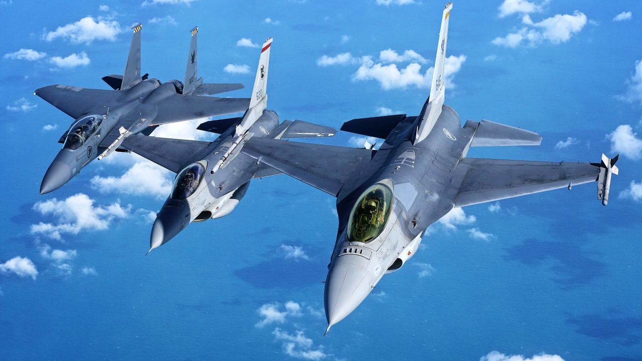 Two Singaporean F-16s fly in formation with an F-15 in 2017. The country's defense minister says the F-16s will be obsolete by 2030.