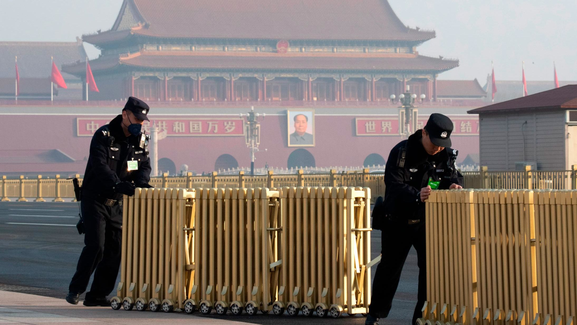 Chinese police officers push away barriers before delegates arrive for a meeting on the eve of the opening session of the National People's Congress, at the Great Hall of the People in Beijing, China, Monday, March 4, 2019. 