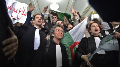 Algerian lawyers protest on February 25, holding up placards with slogans in Arabic that read: "The lawyers are with the people."