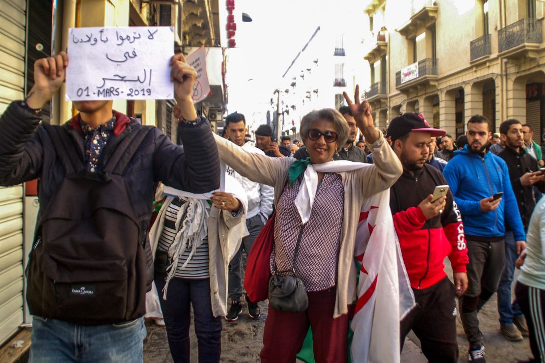 A protester holds a sign reading "Don't throw our kids into the sea" during a demonstration in Oran on Friday.