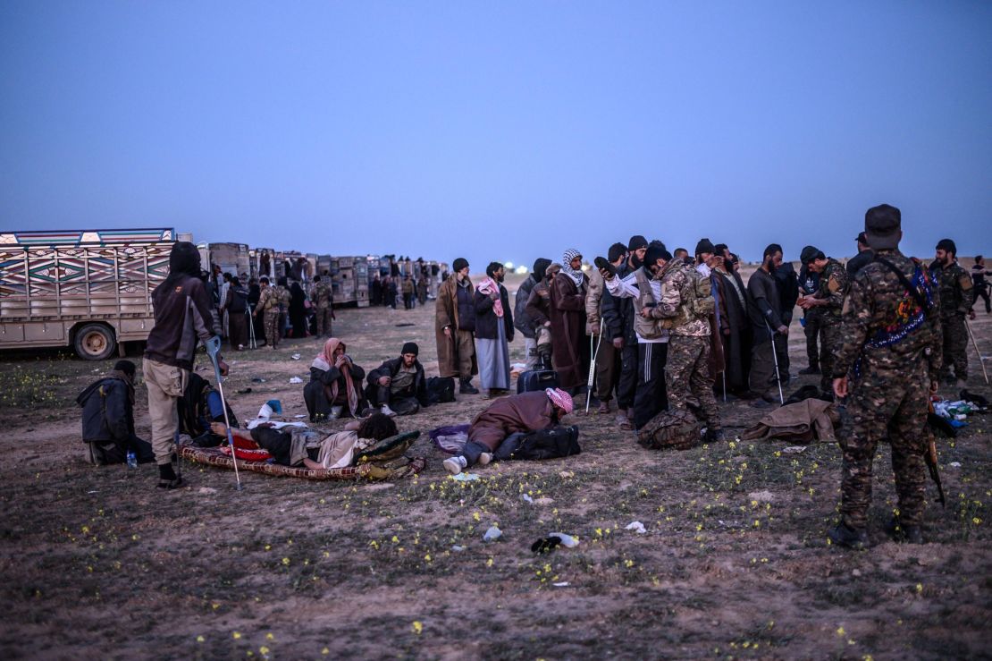 Suspected ISIS fighters who fled Baghouz await processing.