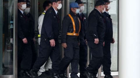Former Nissan chairman Carlos Ghosn, wearing a  blue cap and a face mask, when he was released on bail.