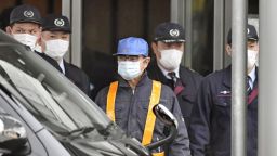 Former Nissan Motor Co. Chairman Carlos Ghosn (wearing blue hat) is released on March 6, 2019, from the Tokyo Detention House, where he was held for 108 days over financial misconduct allegations. (Kyodo via AP Images) ==Kyodo