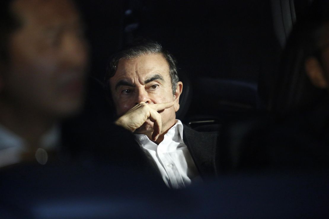 Carlos Ghosn in a vehicle as he leaves his lawyer's office after being freed on bail.