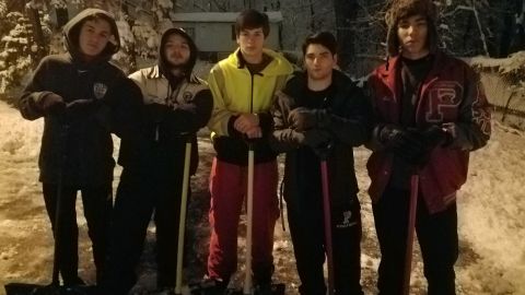 Patrick Lanigan and his friends shovel neighbor's driveway during winter storm