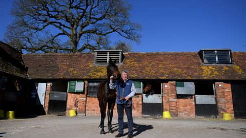 Trainer Paul Nicholls poses with Clan Des Obeaux at his Manor Farm Stables in Somerset, England.