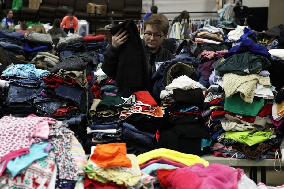 A volunteer in Opelika, Alabama, sorts donated clothes for tornado victims on Tuesday, March 5.